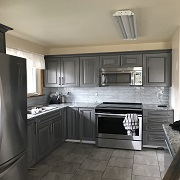 Modern gray kitchen with glass backsplash